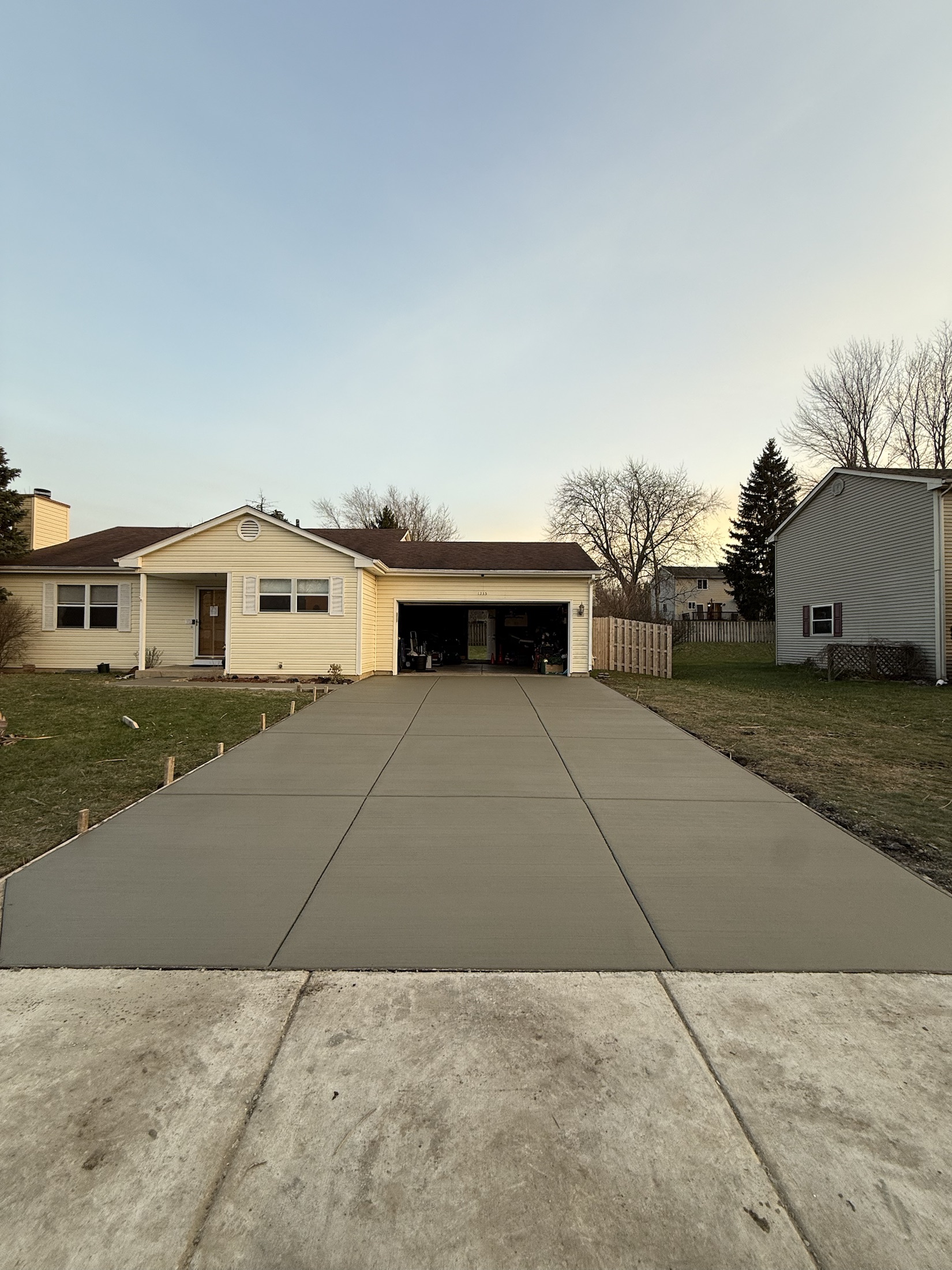 Wide concrete driveway replacement by PFS Concrete & Asphalt