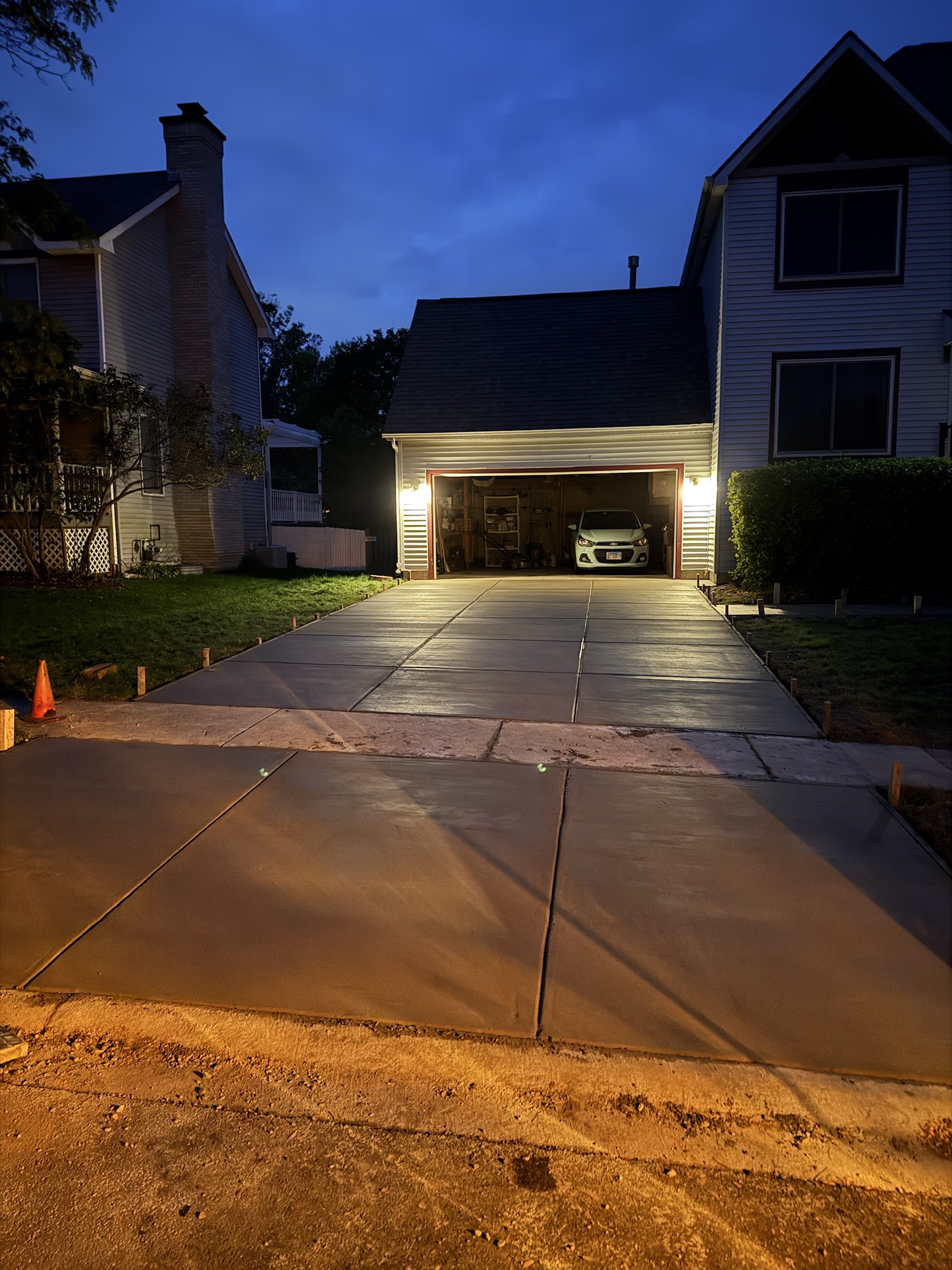 Evening concrete driveway finish by PFS Concrete & Asphalt